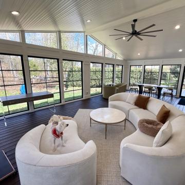 Bright three season room with vaulted ceiling and black framed windows