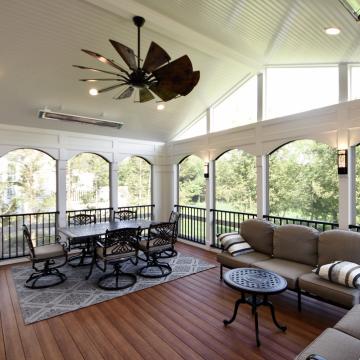Bright three season room with vaulted ceiling, dining and lounge seating