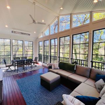 Bright three season room with vaulted ceiling and tall windows