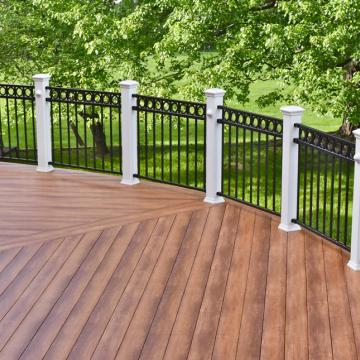 Curved wood deck with black metal railing and white posts