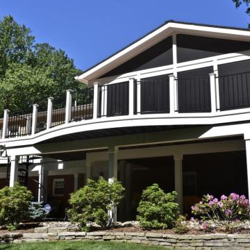 Elevated screen porch with black panels and white framing