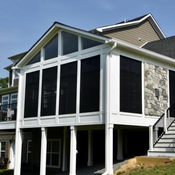 Elevated three season room with screened walls and gabled roof