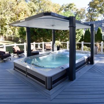 Modern deck with covered hot tub and white railing