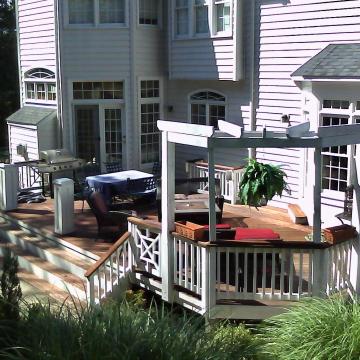 Multi-level backyard deck with pergola, hot tub, and seating