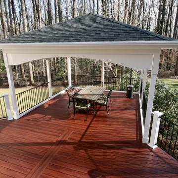 Open air porch with hip roof over deck dining area