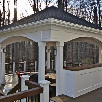 Open air porch pavilion with white columns and dark roof