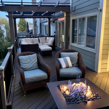 Open air porch with pergola seating and fire table
