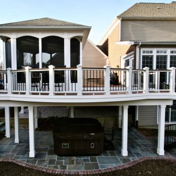 Raised deck with screened porch, spiral stairs, and covered patio