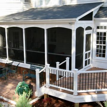 Screened porch addition with white trim and adjacent wood deck