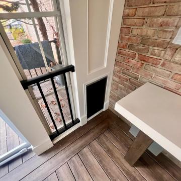 Screened porch corner with brick wall, bench, and pet door