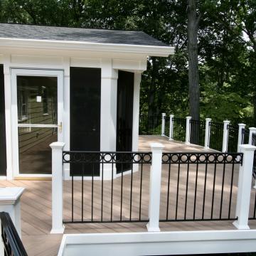 Screened porch entry and deck with black metal railing