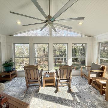 Bright three season room with vaulted ceiling and large windows