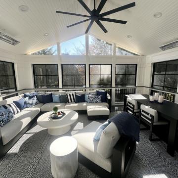 Bright three season room with vaulted ceiling, sectional seating, and dining table