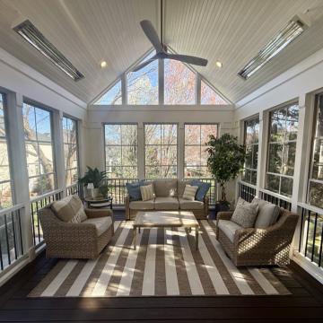 Bright three season room with vaulted ceiling and wicker seating