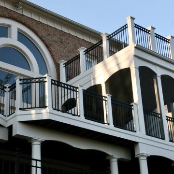 Two-story screened porch with rooftop deck and black railings