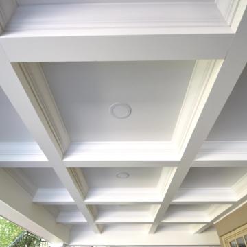 White coffered porch ceiling with recessed lights and trim details