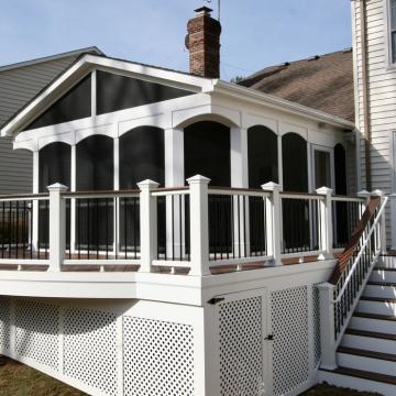 White elevated screen porch with black screens and stair access
