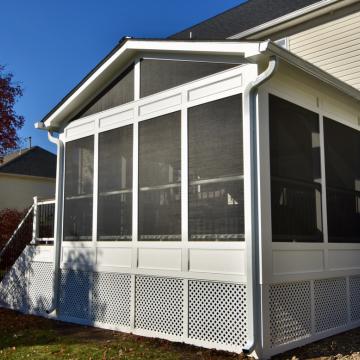 White gabled screen porch addition with dark mesh panels