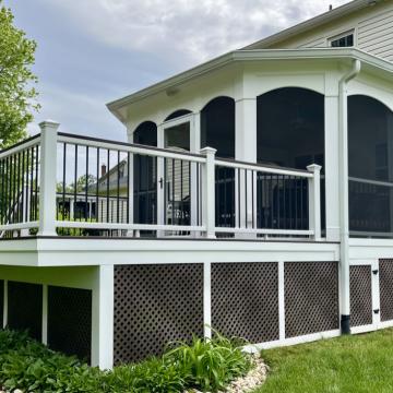 White screened porch with adjacent deck and black railings