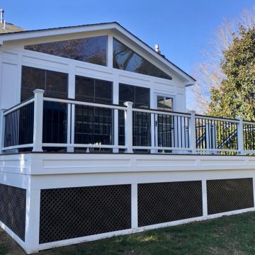 White screened porch with elevated deck and black railing
