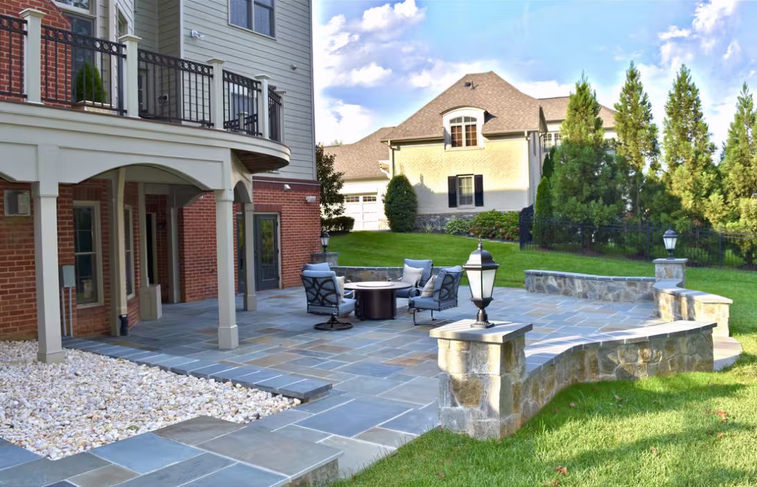 Stone patio with seating area and curved retaining wall
