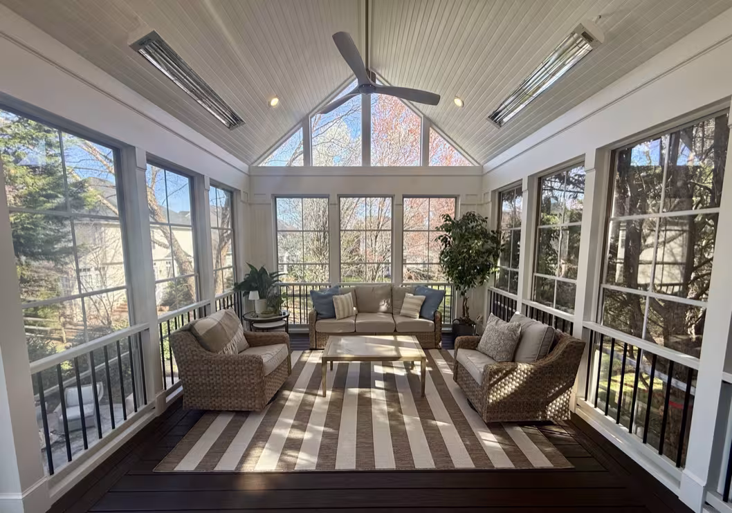 Bright three season room with vaulted ceiling and wicker seating